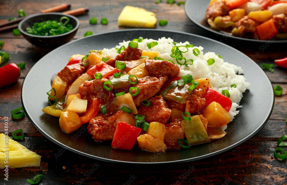 Pineapple and Chicken in sweet and sour sauce with bell pepper, rice and spring onion