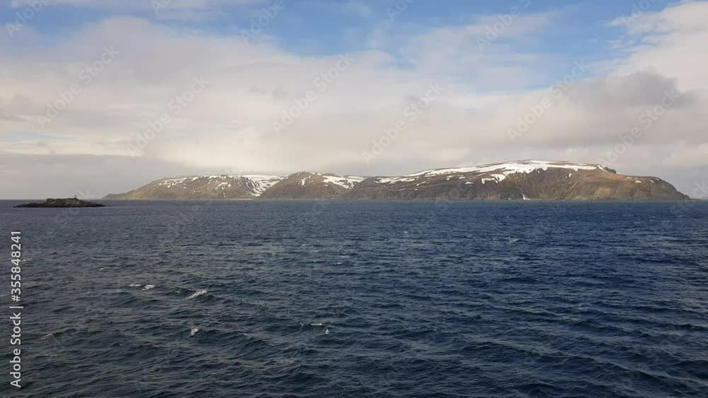 mighty sea and snowy mountain view sailing a ship in Finnmark, northern Norway mighty sea and snowy mountain view sailing a ship in Finnmark, northern Norway