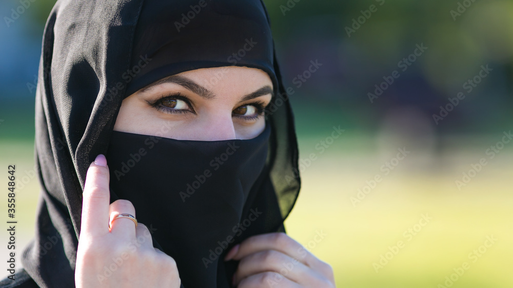 Arab woman in a black scarf on her head. Muslim woman with beautiful eyes in national dress. Arab woman in a black scarf on her head. Muslim woman with beautiful eyes in national dress.