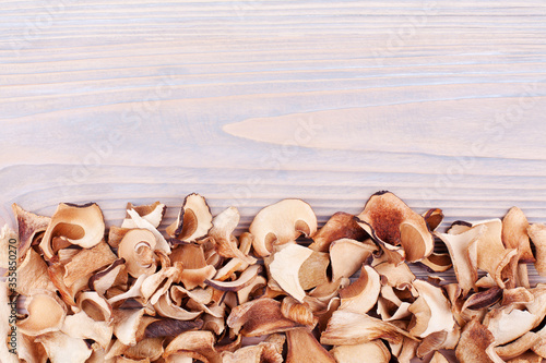 Wallpaper Mural Edible dried mushrooms border on light wooden background closeup top view, dry boletus edulis on wood backdrop frame, brown cap boletus, penny bun, cep, porcino, porcini, white fungus, text copy space Torontodigital.ca