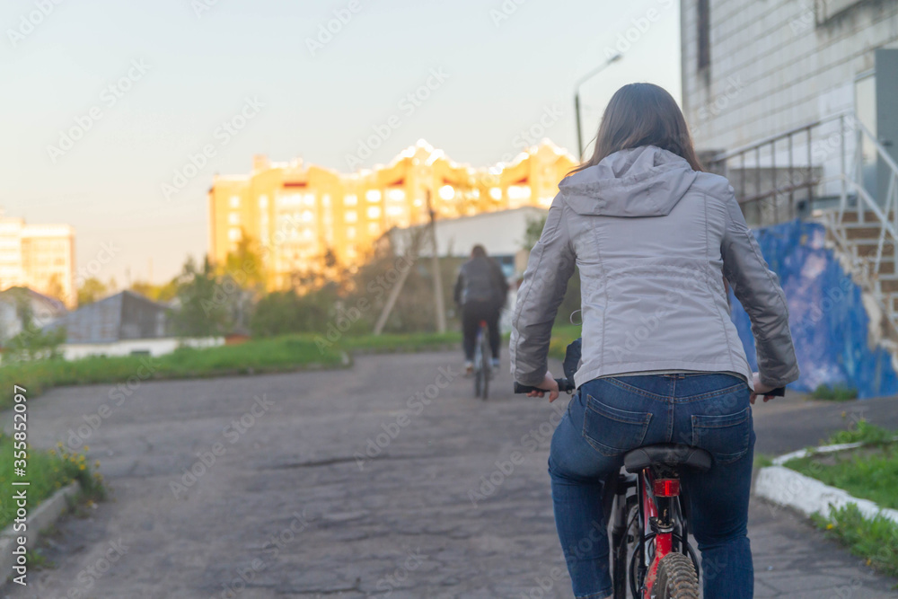 A woman rides a Bicycle on the road. Bike ride.