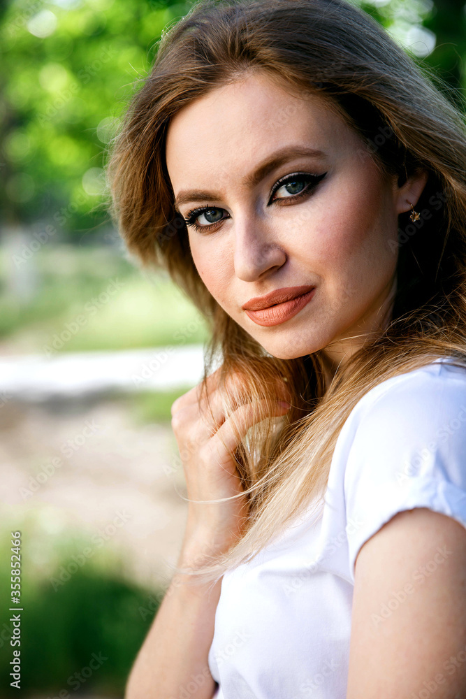 Attractive girl in a white T-shirt on the street. Mock-up. Attractive girl in a white T-shirt on the street. Mock-up.