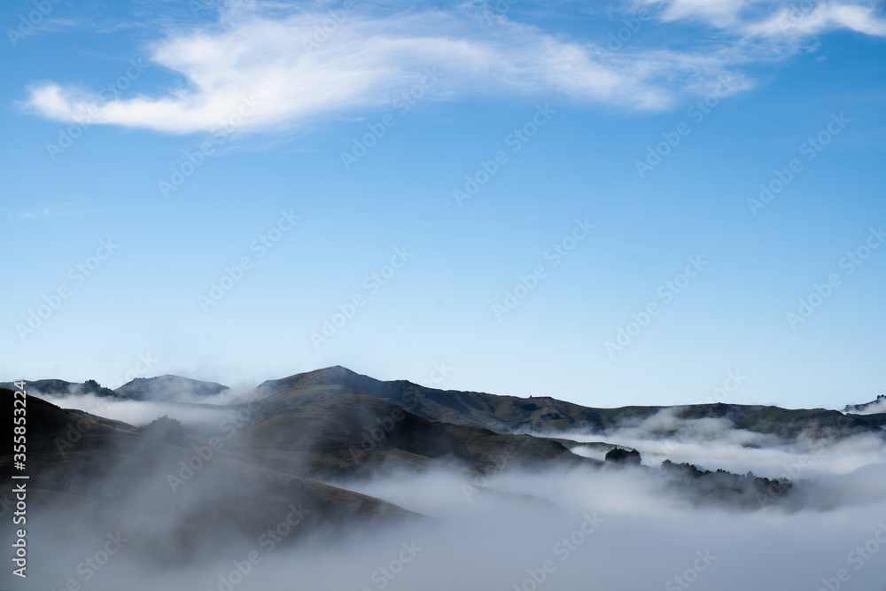 Silhouette of mountains in the misty morning. View of the mountains in early winter. Beautiful nature landscape. Bank Peninsula, Robinsons bay, Canterbury, Ndw Zealand.