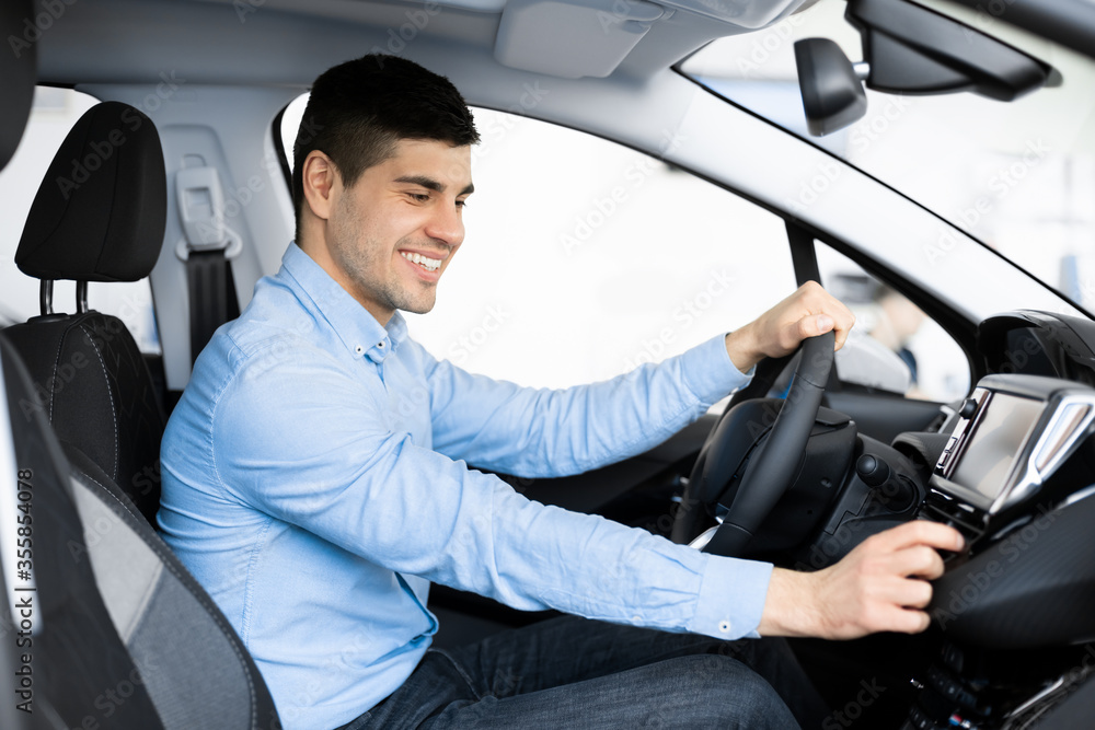 Businessman Sitting In New Auto Checking Dashboard Businessman Sitting In New Auto Checking Dashboard