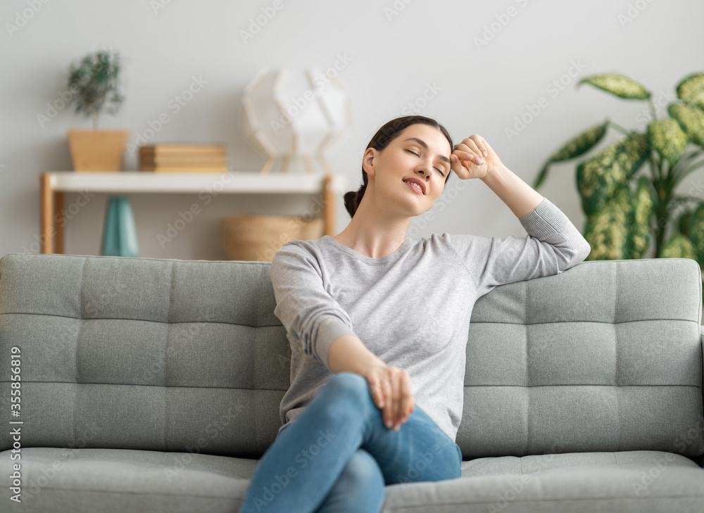 woman resting on sofa at home woman resting on sofa at home