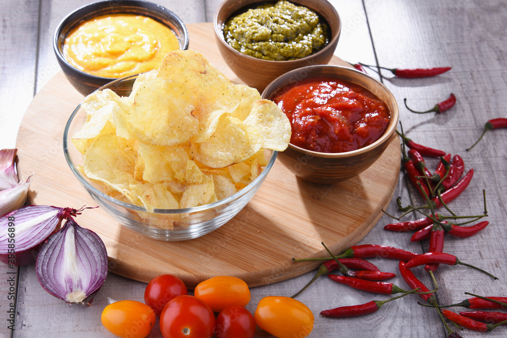 Composition with bowl of potato chips. Composition with bowl of potato chips.