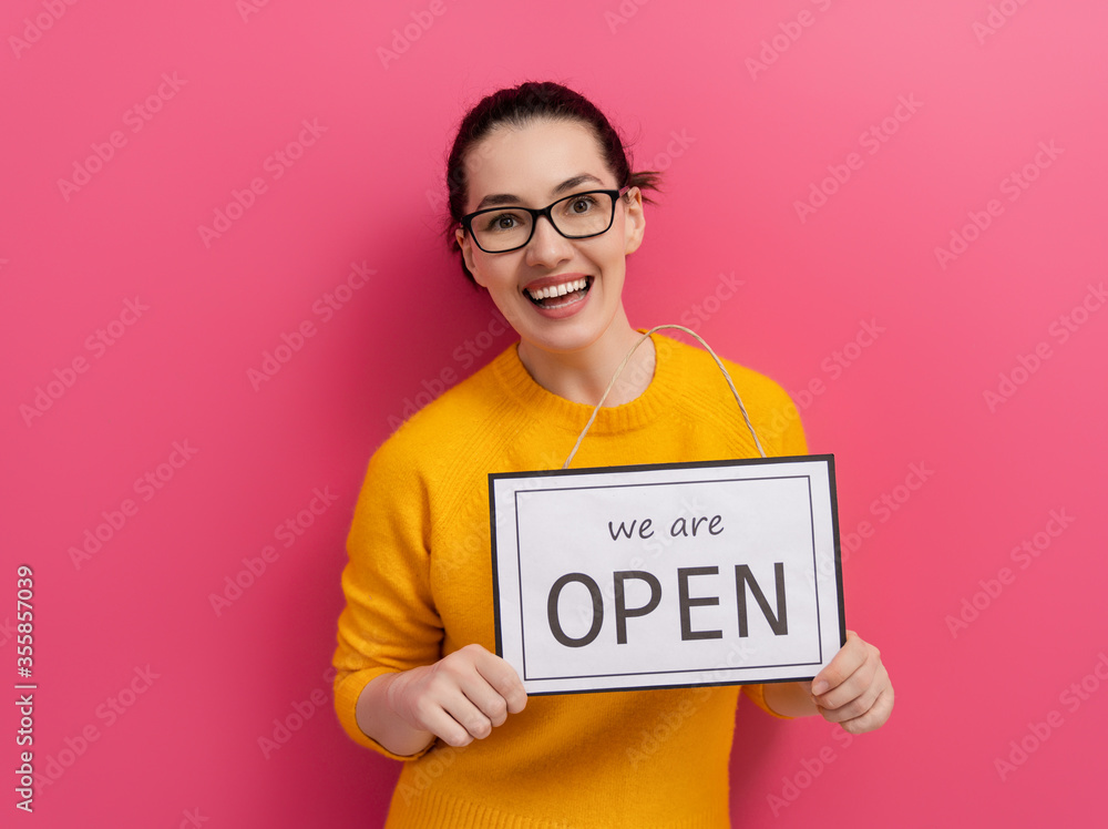 business owner holding the sign for the reopening business owner holding the sign for the reopening