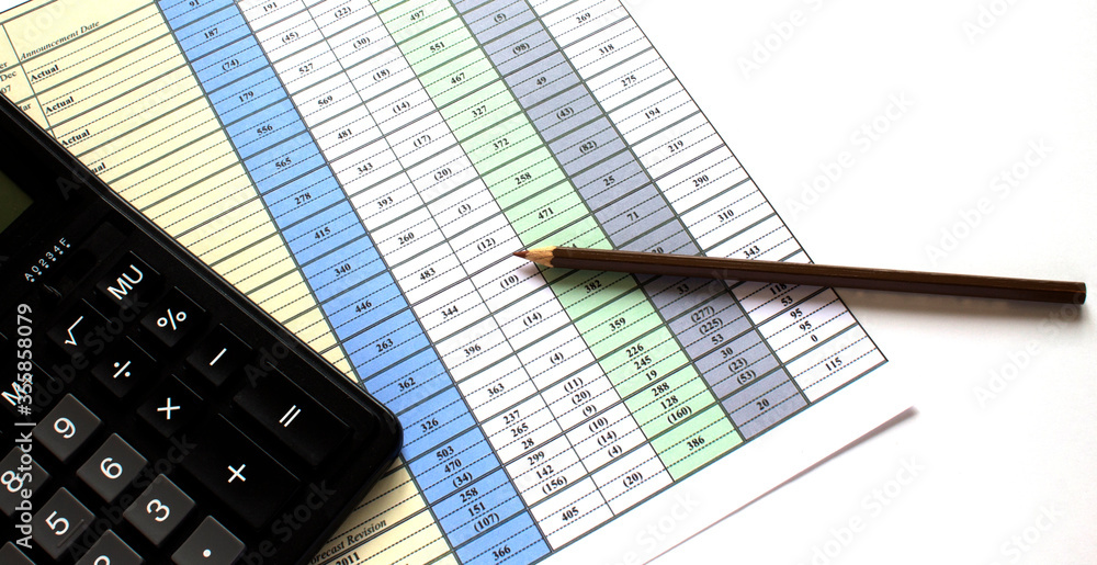 Calculator on the business graphs. Finance conzept Calculator on the business graphs. Finance conzept