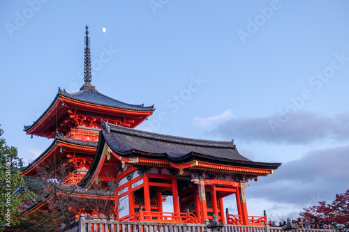 The pagoda in Kiyomizu dera temple  Kyoto  Japan  in the dusk with the moon and the twilight sky in autumn. The pagoda in Kiyomizu dera temple  Kyoto  Japan  in the dusk with the moon and the tw
