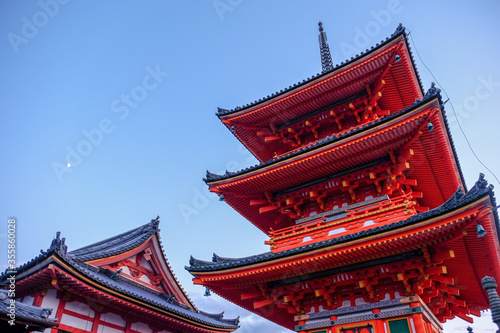The pagoda in Kiyomizu dera temple, Kyoto, Japan, in the dusk with the moon and the twilight sky in autumn. 