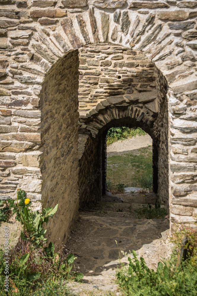 Gateway through the wall of a medieval castle ruin.