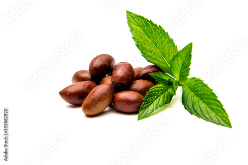 Kalamata olives with mint leaves on a white background