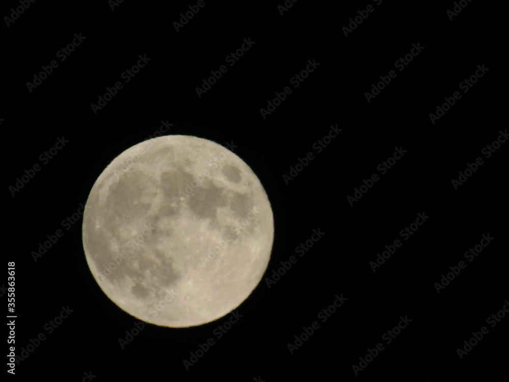 An amazing photography of the full moon over the city of Genova by night with a great clear sky in background and some stars An amazing photography of the full moon over the city of Genova by night with a great clear sky in background and some stars