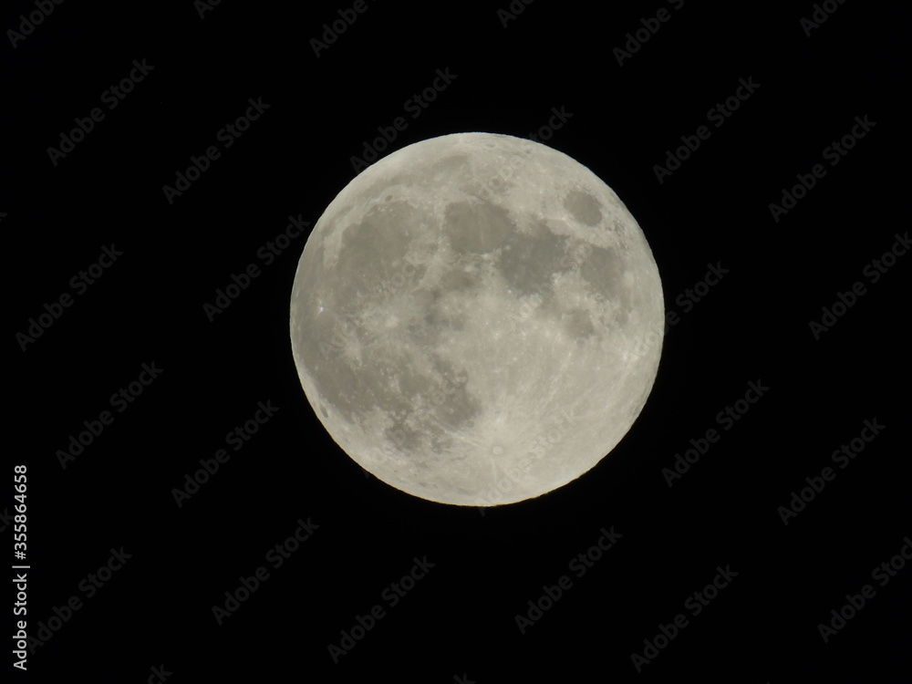 An amazing photography of the full moon over the city of Genova by night with a great clear sky in background and some stars An amazing photography of the full moon over the city of Genova by night with a great clear sky in background and some stars