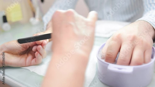 a manicurist saws a man's nails. High quality FullHD footage