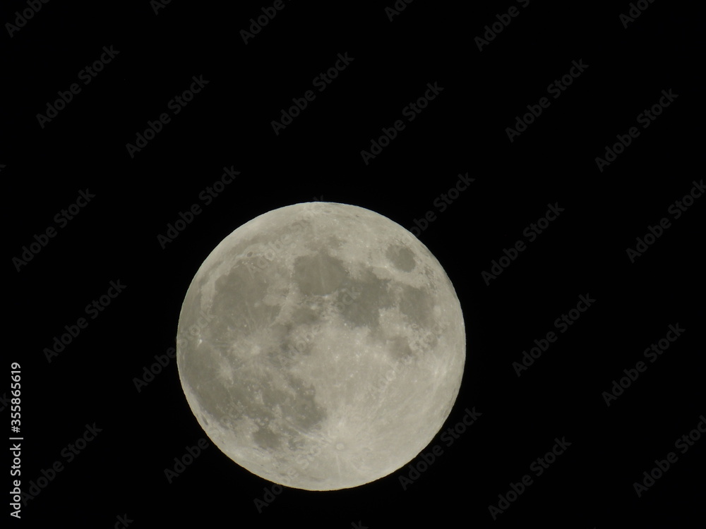 An amazing photography of the full moon over the city of Genova by night with a great clear sky in background and some stars An amazing photography of the full moon over the city of Genova by night with a great clear sky in background and some stars