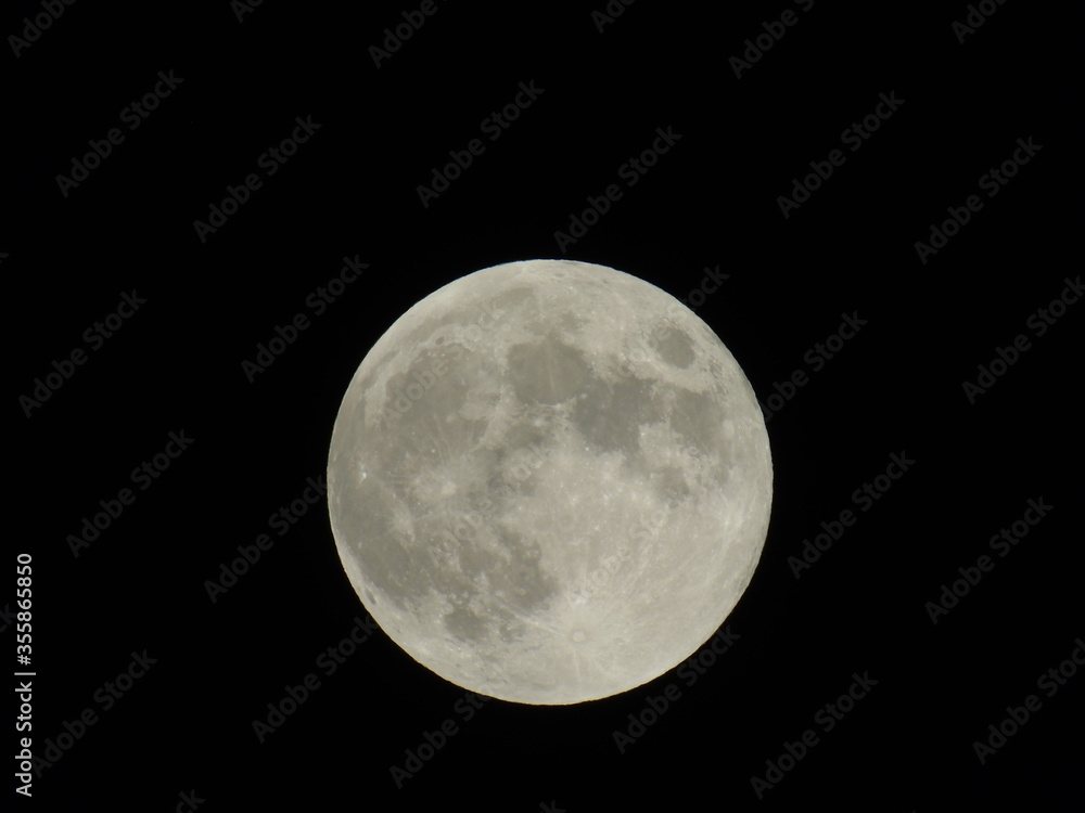 Naklejka premium An amazing photography of the full moon over the city of Genova by night with a great clear sky in background and some stars