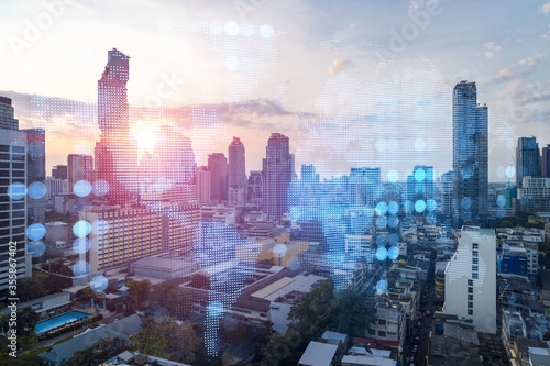 Photography Multi exposure of Bangkok cityscape sunrise background and world map hologram