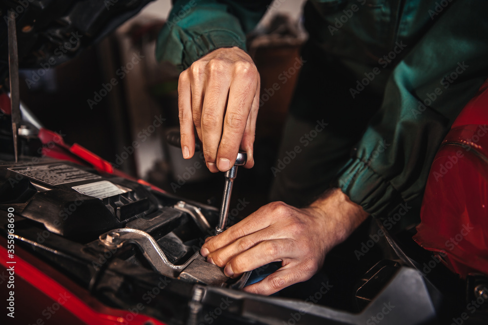 Male hands close-up. Auto mechanic works in the garage. Repair service. Male hands close-up. Auto mechanic works in the garage. Repair service.