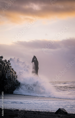 Waves and basalt cliffs at Reynisfjara Beach - Iceland photo