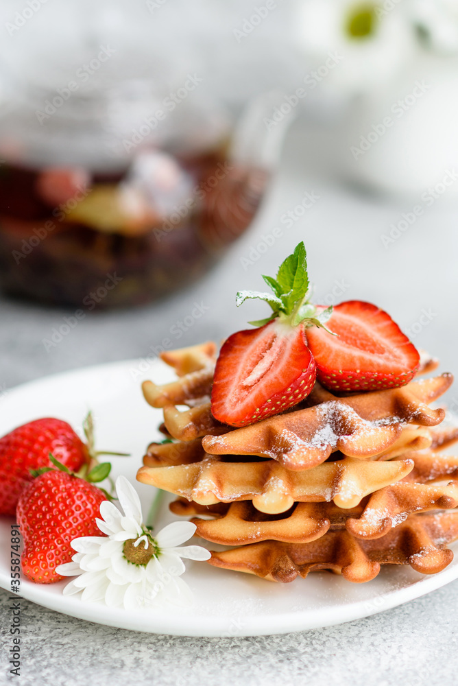 Delicious fresh baked belgian waffles with berries and fruit Delicious fresh baked belgian waffles with berries and fruit