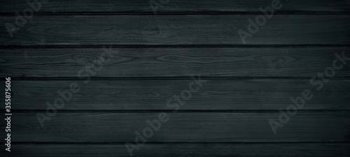 Black painted wooden board widescreen texture. Wood plank surface top view. Dark retro background photo