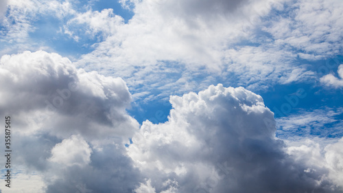 The blue sky and clouds gather on a bright day.