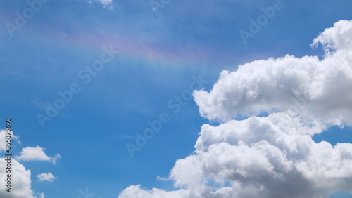 The sky had light clouds and rainbows.