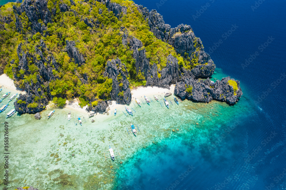 Shimizu Island, El Nido, Palawan, Philippines. Beautiful aerial view of tropical island, sandy beach, coral reef and sharp limestone cliffs