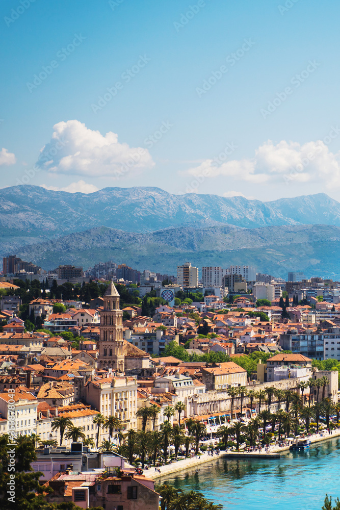 Split, Croatia, city scape in sunny day with Asian tourist posing on stone balcony