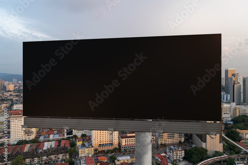 Photography Blank black road billboard with Kuala Lumpur cityscape background at sunset