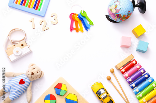 Colorful kids toys on white background. Top view, flat lay.