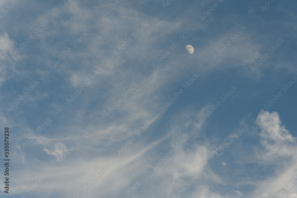 moon and clouds during daylight