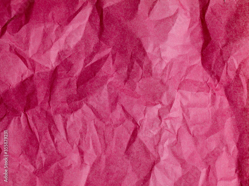 The texture of crumpled paper is maroon. top view