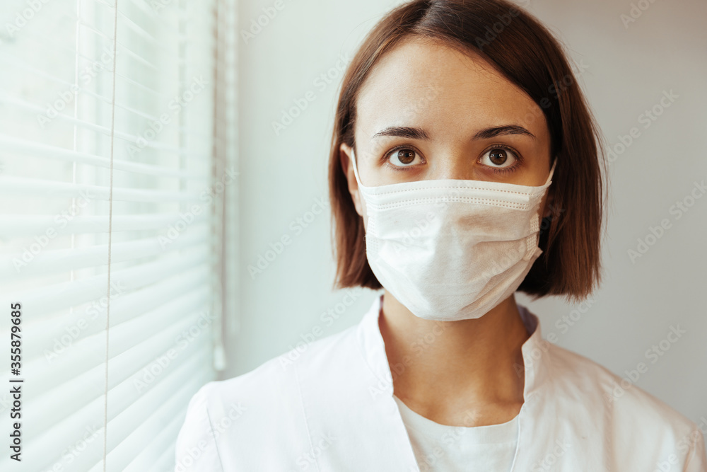 Closeup portrait of a girl doctor. Masked doctor Closeup portrait of a girl doctor. Masked doctor