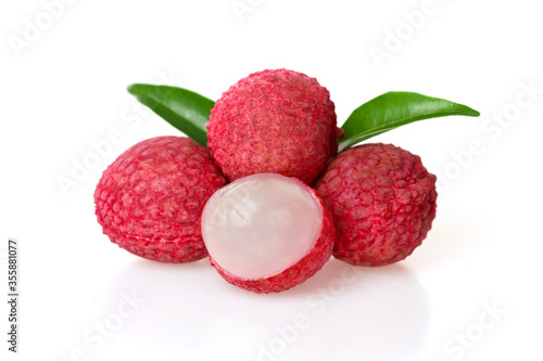 Close up of fresh summer tropical fruits Fresh red lychee fruit and peeled lychee decorated with green leaves, Lychee has a sweet and sour taste, isolated on white.