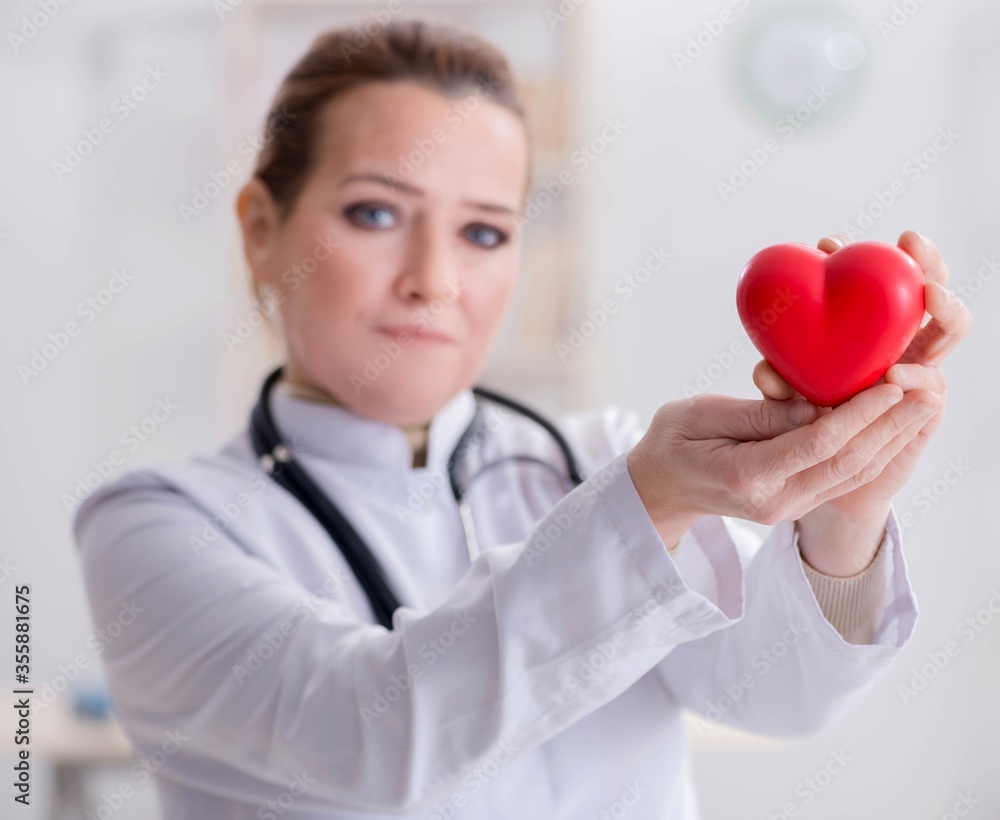 Cardiologist with red heart in medical concept Cardiologist with red heart in medical concept