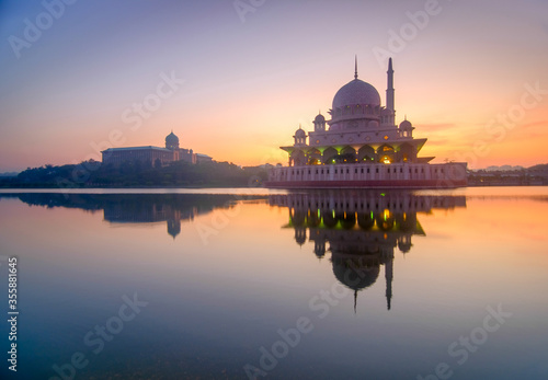 Beautiful sunrise in putrajaya malaysia with reflection in lake water with mosque in visibility. Putrajaya in administrative capital of malaysia. Selective focus.