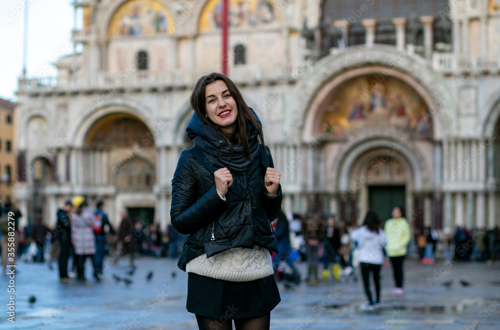 horizontal photo of a smiling european tourist girl on Piazza San Marco