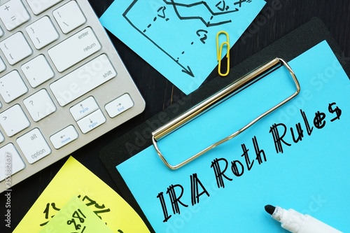 Business concept meaning IRA Roth Rules with sign on the piece of paper.