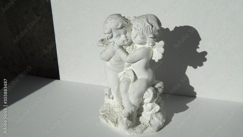           figurine of two hugging gypsum angels                     