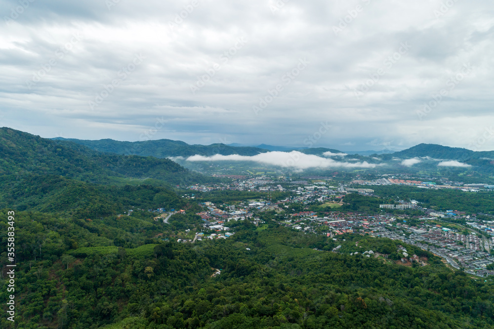 Aerial view drone shot of tropical rainforest Amazing nature background with fog and mountain peaks.