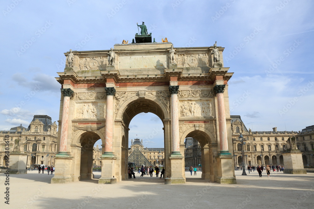 Paris, France - April 2014: the Arc de Triomphe du Carrousel in front of the Tuileries Gardens seen from the courtyard of the Louvre. It was built by Napoleon for military victories.
