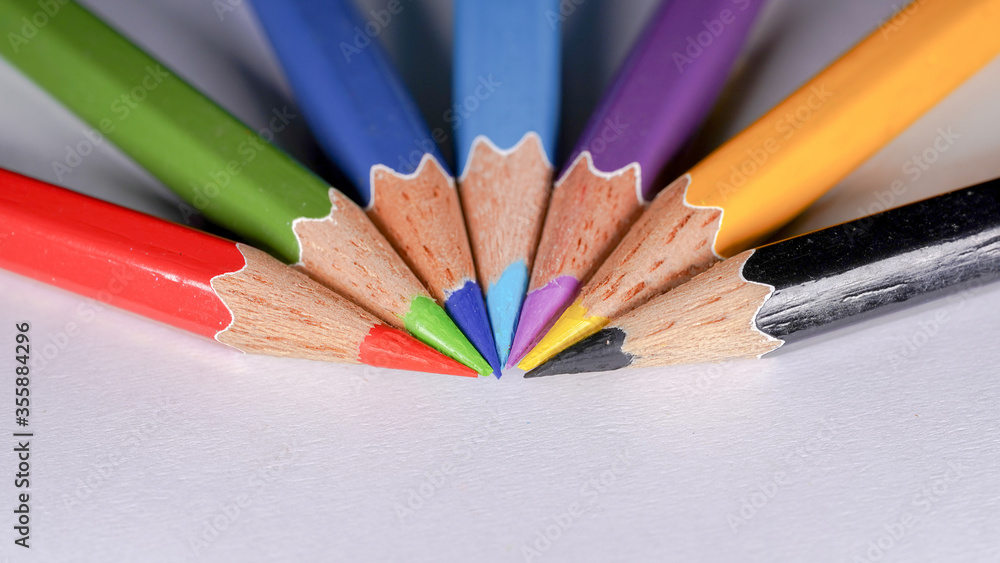 colored pencils on a wooden table colored pencils on a wooden table