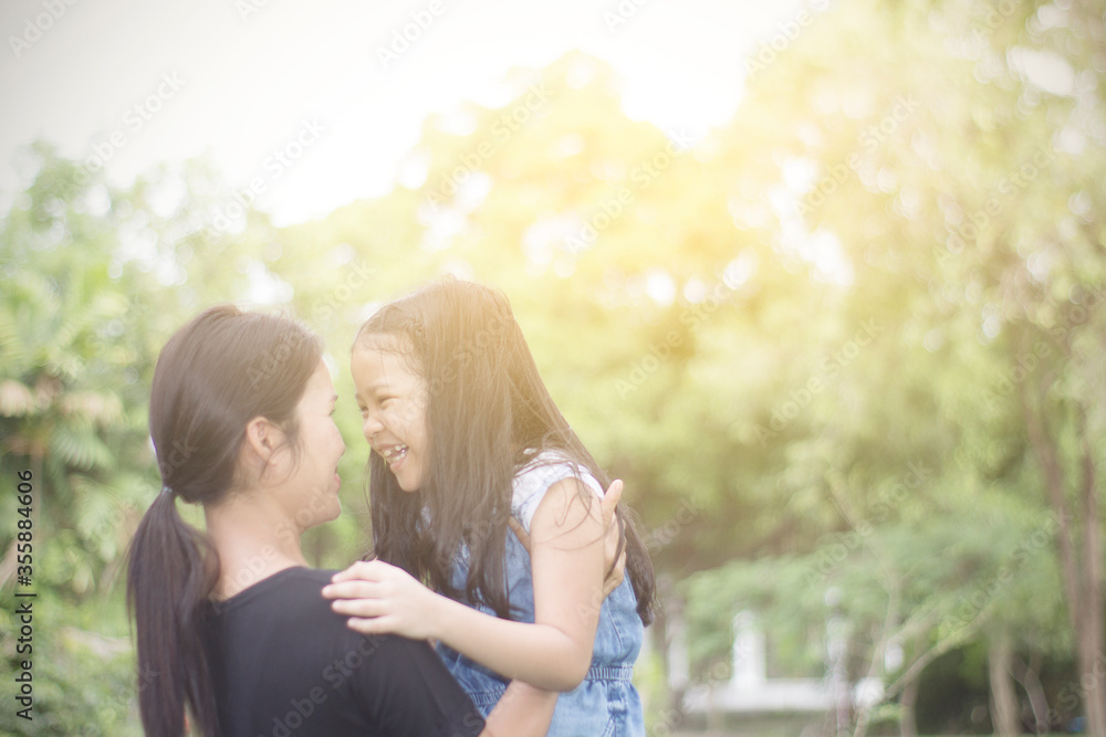 Fototapeta premium Mother hugs child with love in natural background