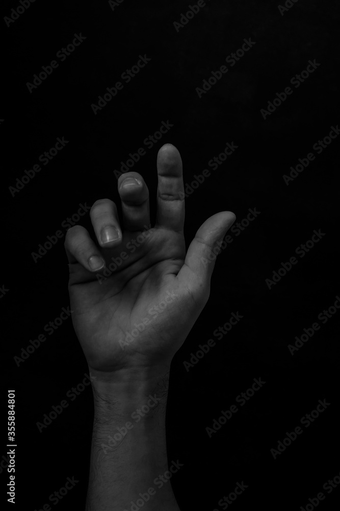 Male black hand gesture isolated on black background
