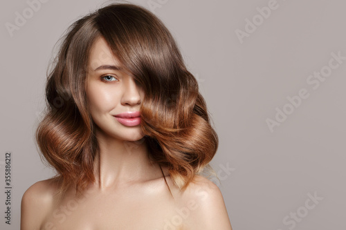 portrait of a young woman. voluminous large curls.