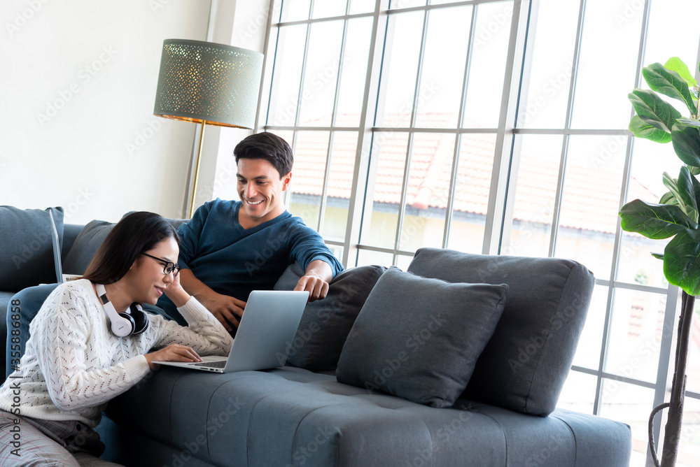 Couple work at home during lock down of corona virus outbreak use laptop connected to internet on concept of working at home Couple work at home during lock down of corona virus outbreak use laptop connected to internet on concept of working at home