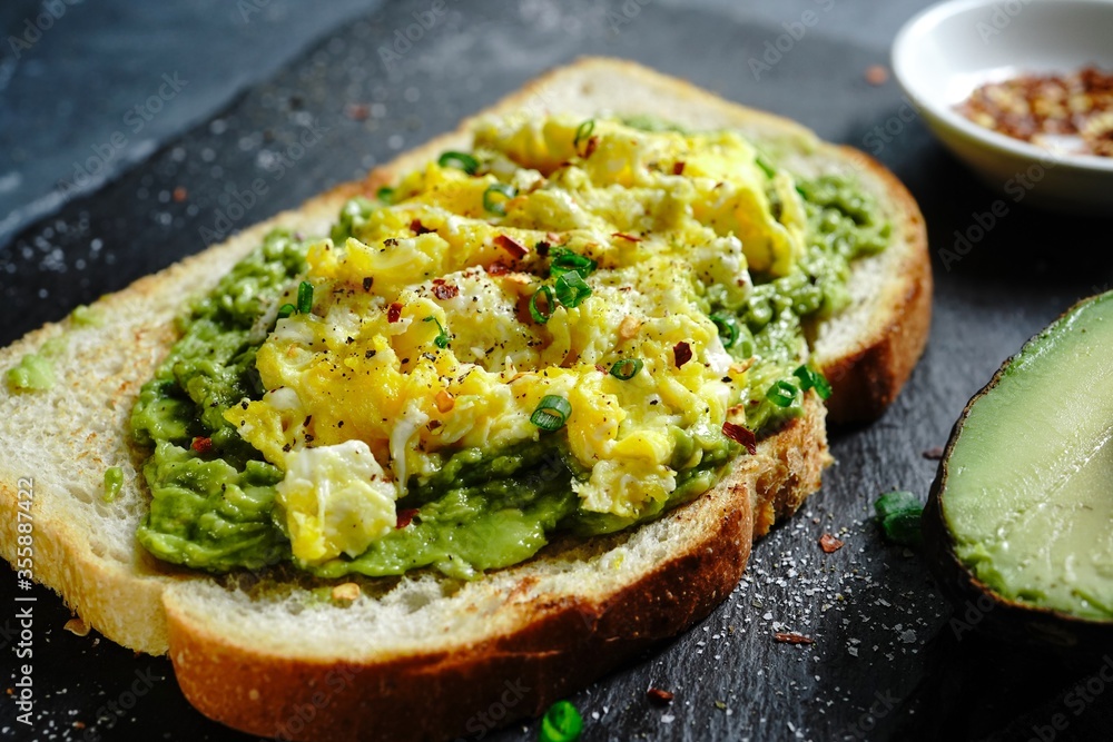 Avocado scrambled egg toast on sourdough bread, selective focus Avocado scrambled egg toast on sourdough bread, selective focus