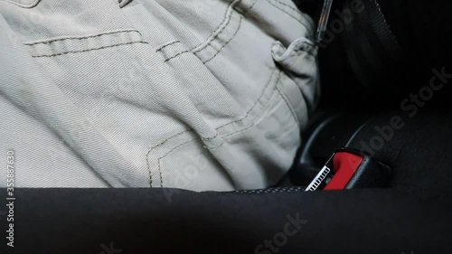 A married adult man unfastening his seal belt after a trip. Concept of release